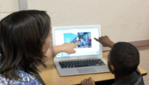 student and teacher read a tar heel shared reader book